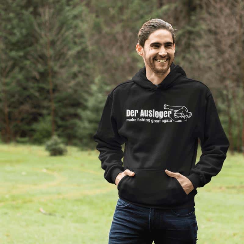 pullover-hoodie-mockup-of-a-smiling-man-in-an-open-green-area-25103